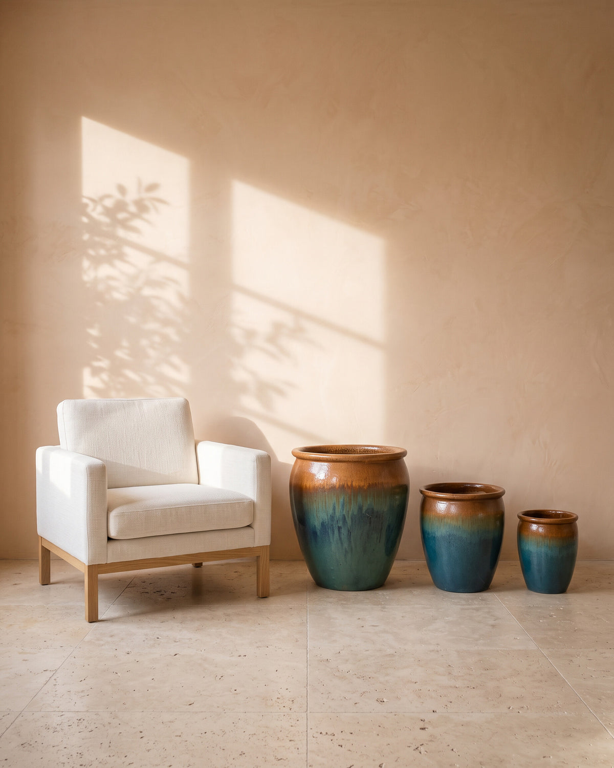 Yellow Blue Ombre Glossy Pot, all sizes, shown beside a linen armchair for scale
