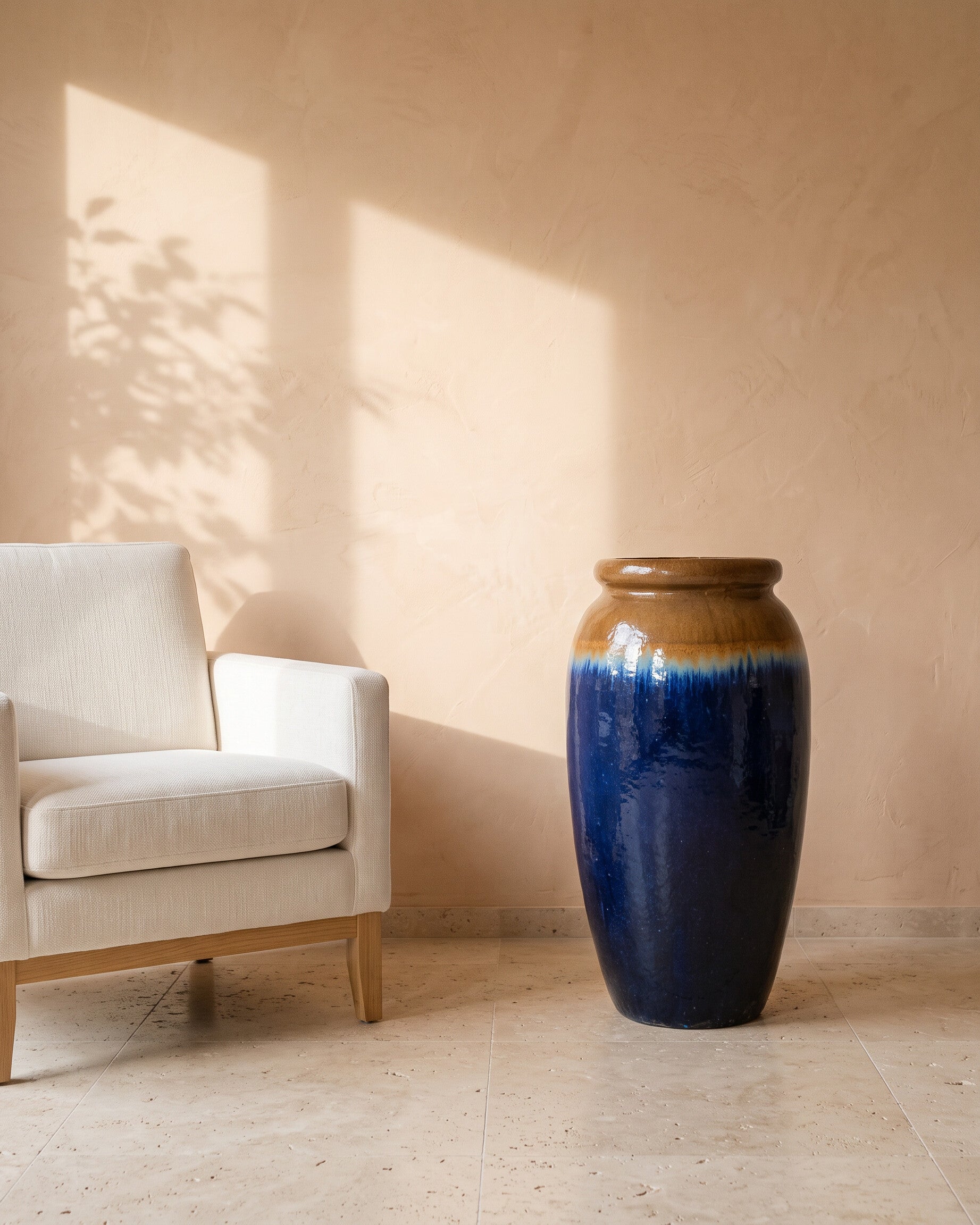 Azure Glow Jar, shown beside a linen armchair for scale