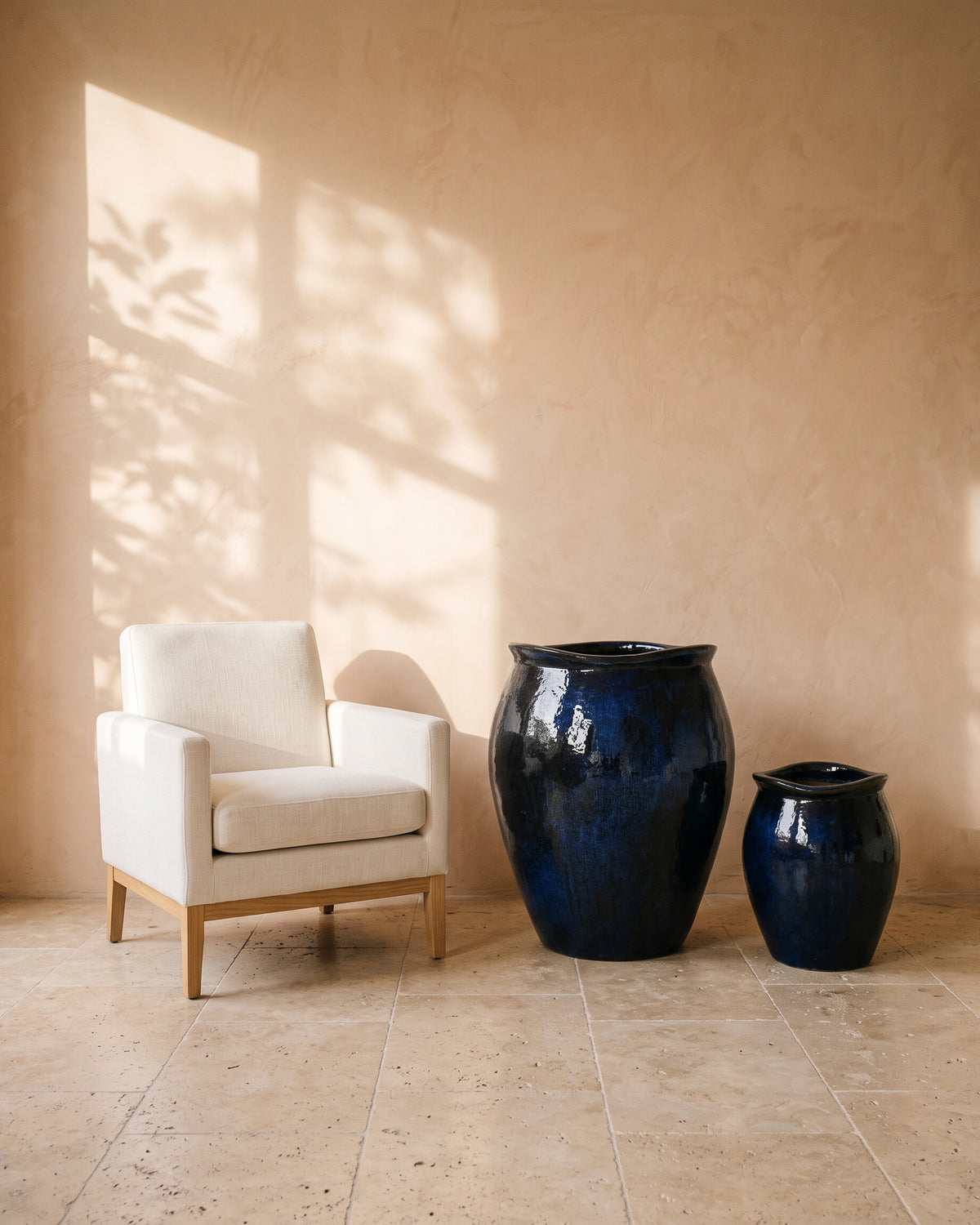 Blue Night Wave-Edge Pot, all sizes, shown beside a linen armchair for scale