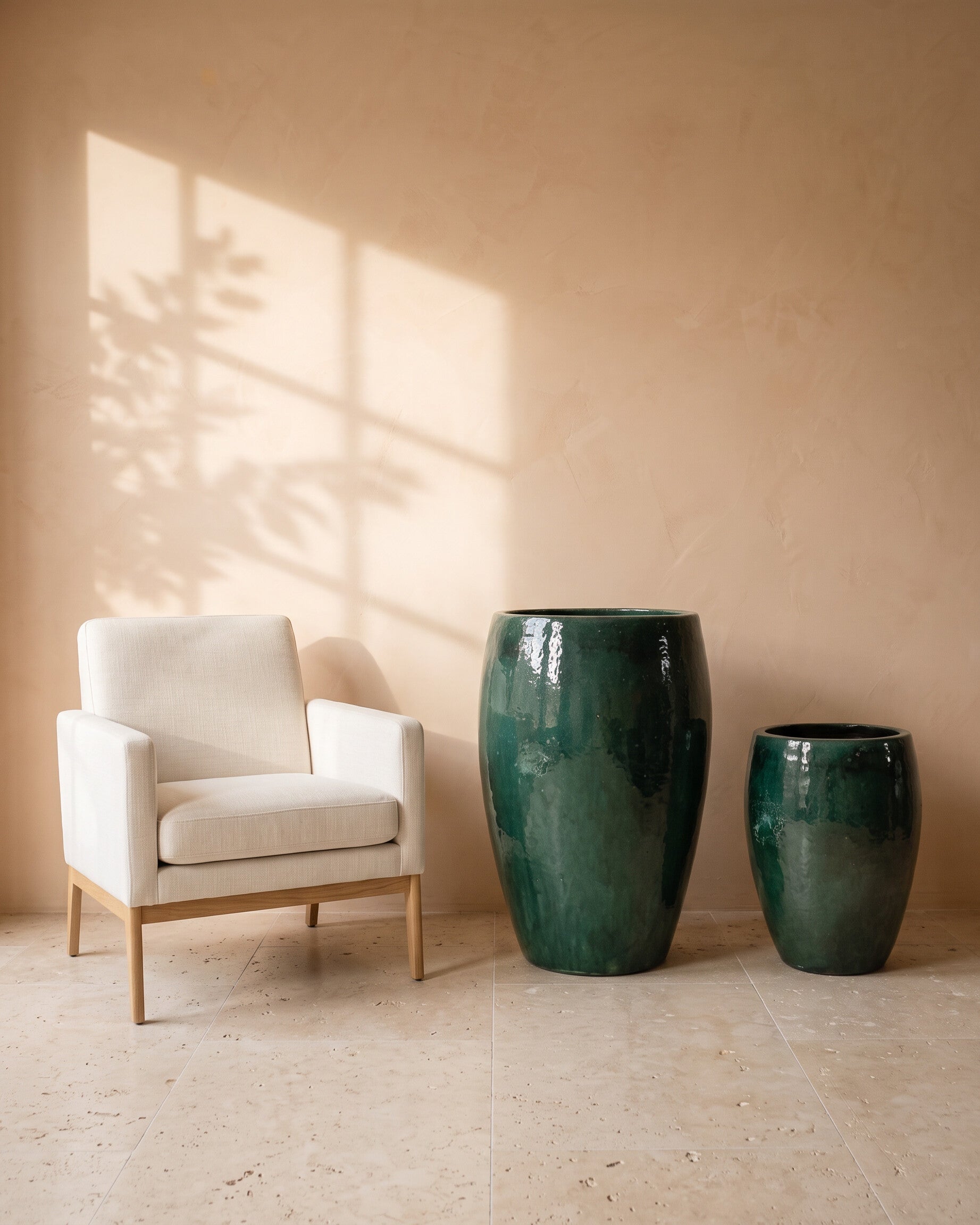 Dark Green Glossy Pot, all sizes, shown beside a linen armchair for scale