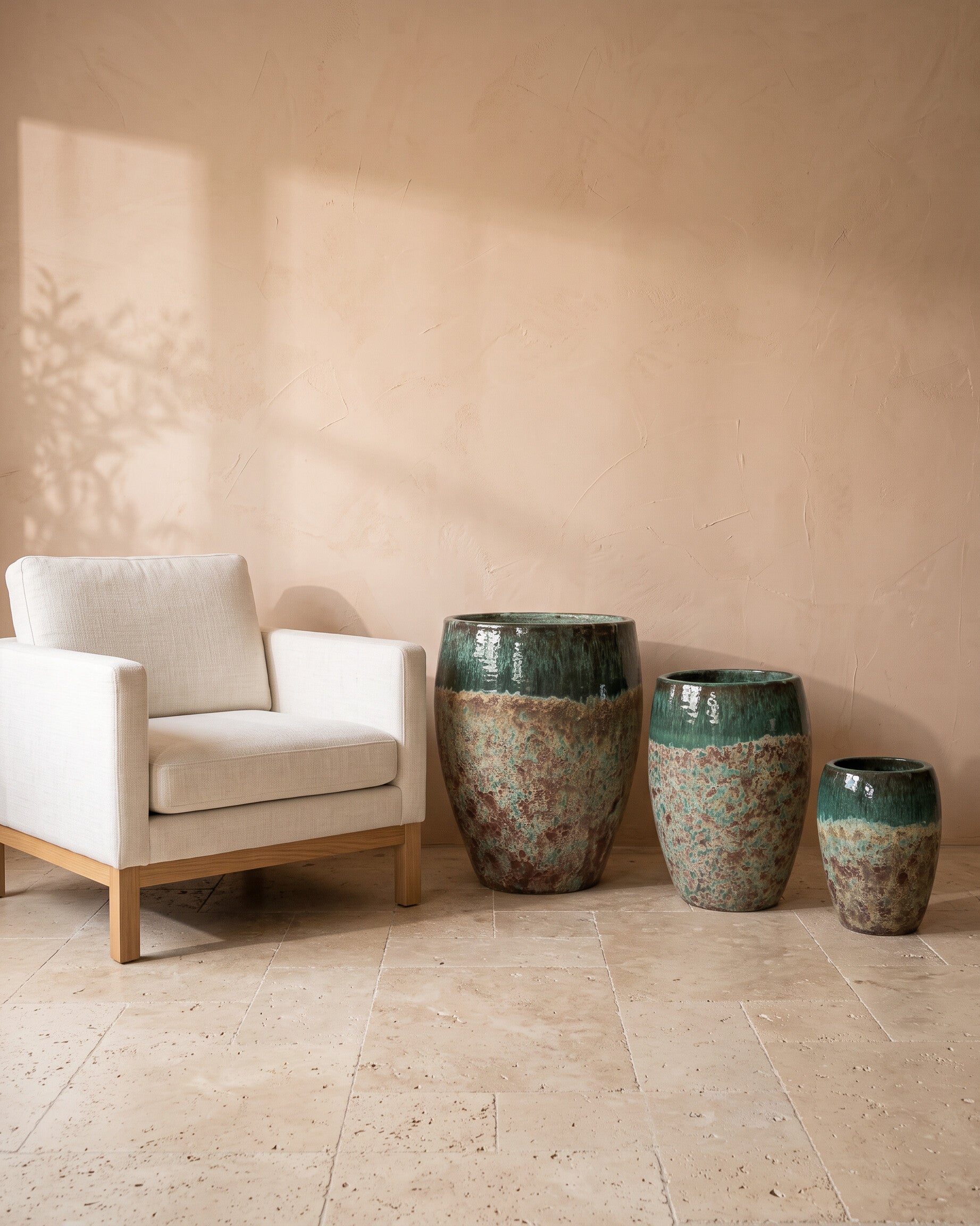 Olive Moss Glazy Pot, all sizes, shown beside a linen armchair for scale
