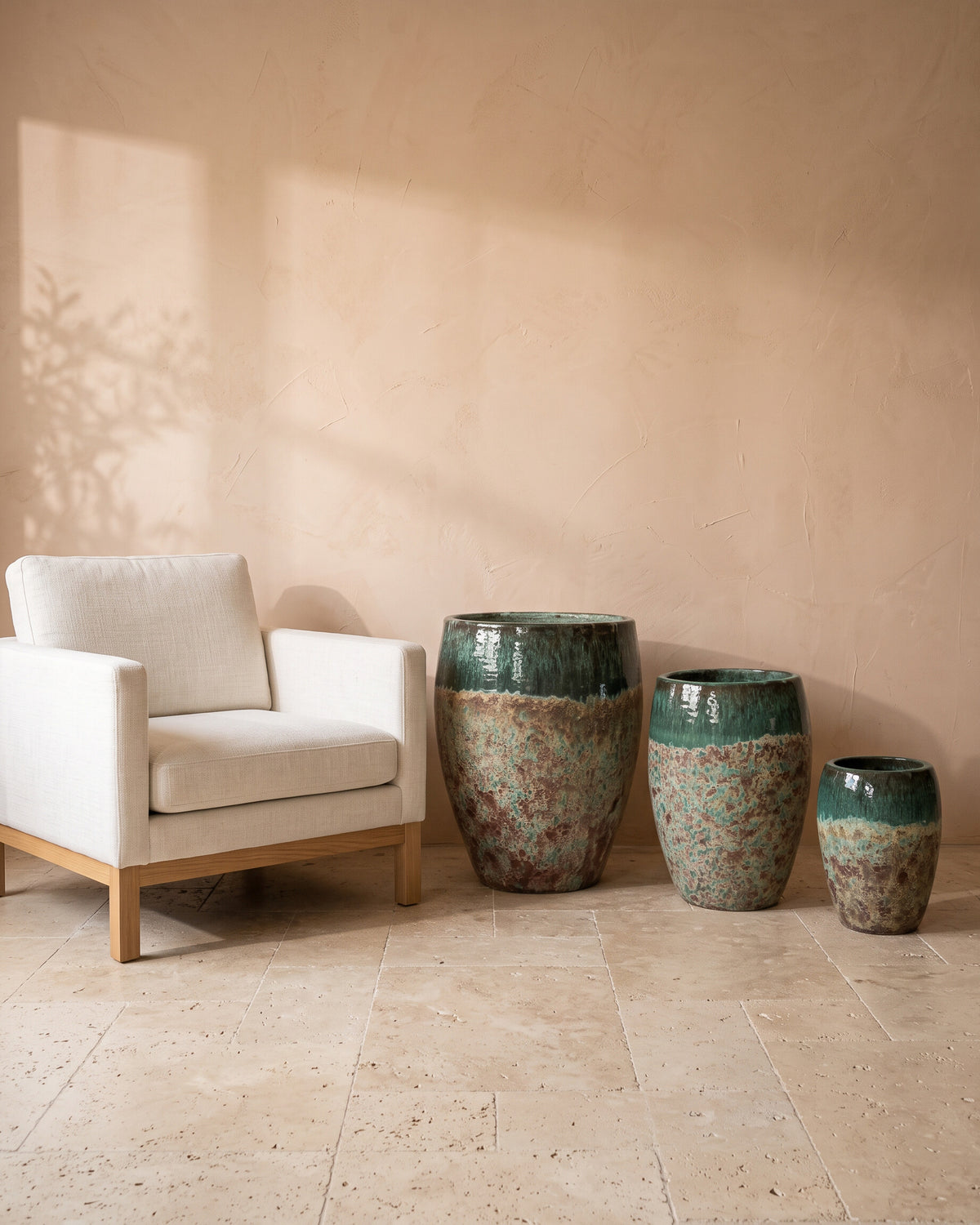 Olive Moss Glazy Pot, all sizes, shown beside a linen armchair for scale
