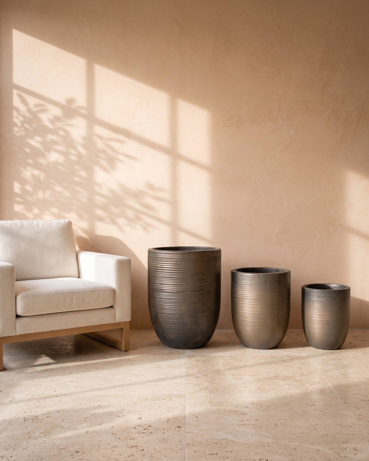 Metallic Glossy Pot, all sizes, shown beside a linen armchair for scale