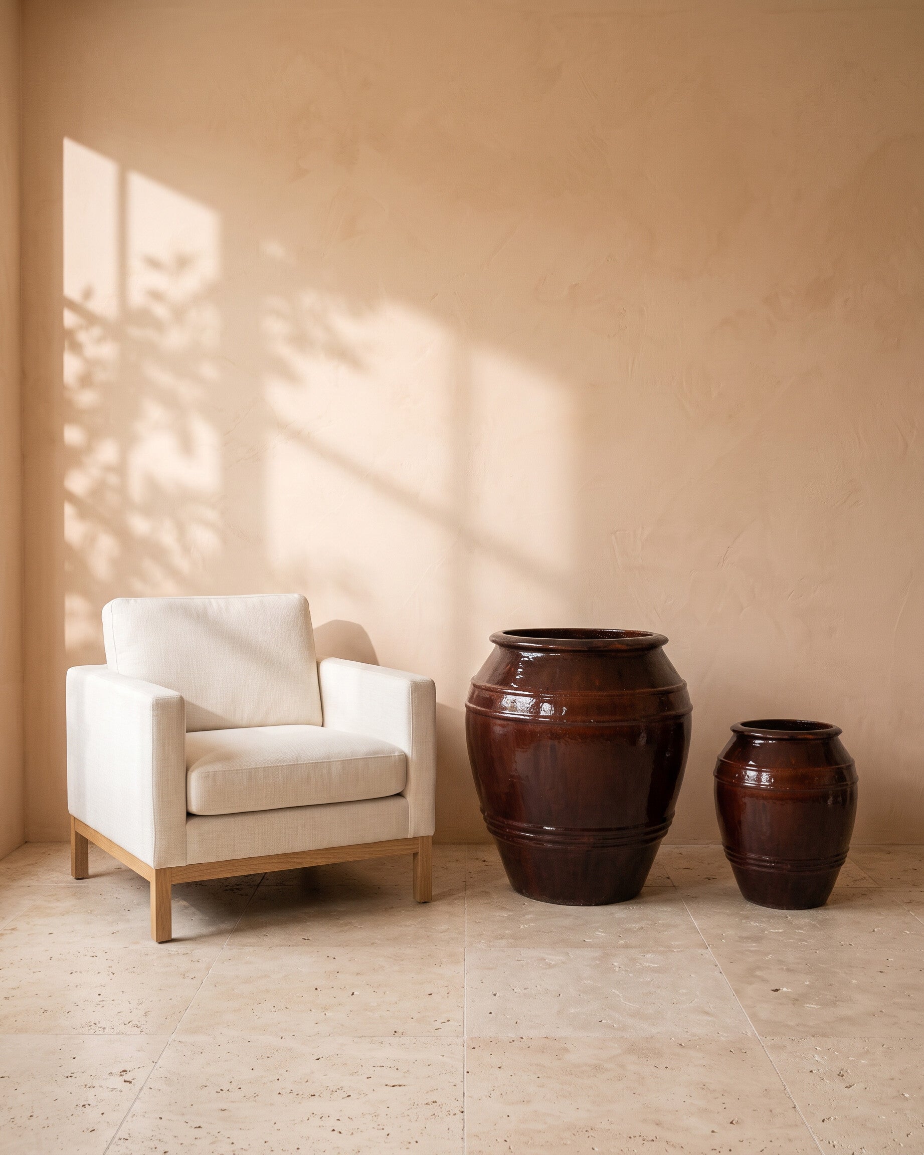 Red Blood Ribbed Pot, all sizes, shown beside a linen armchair for scale