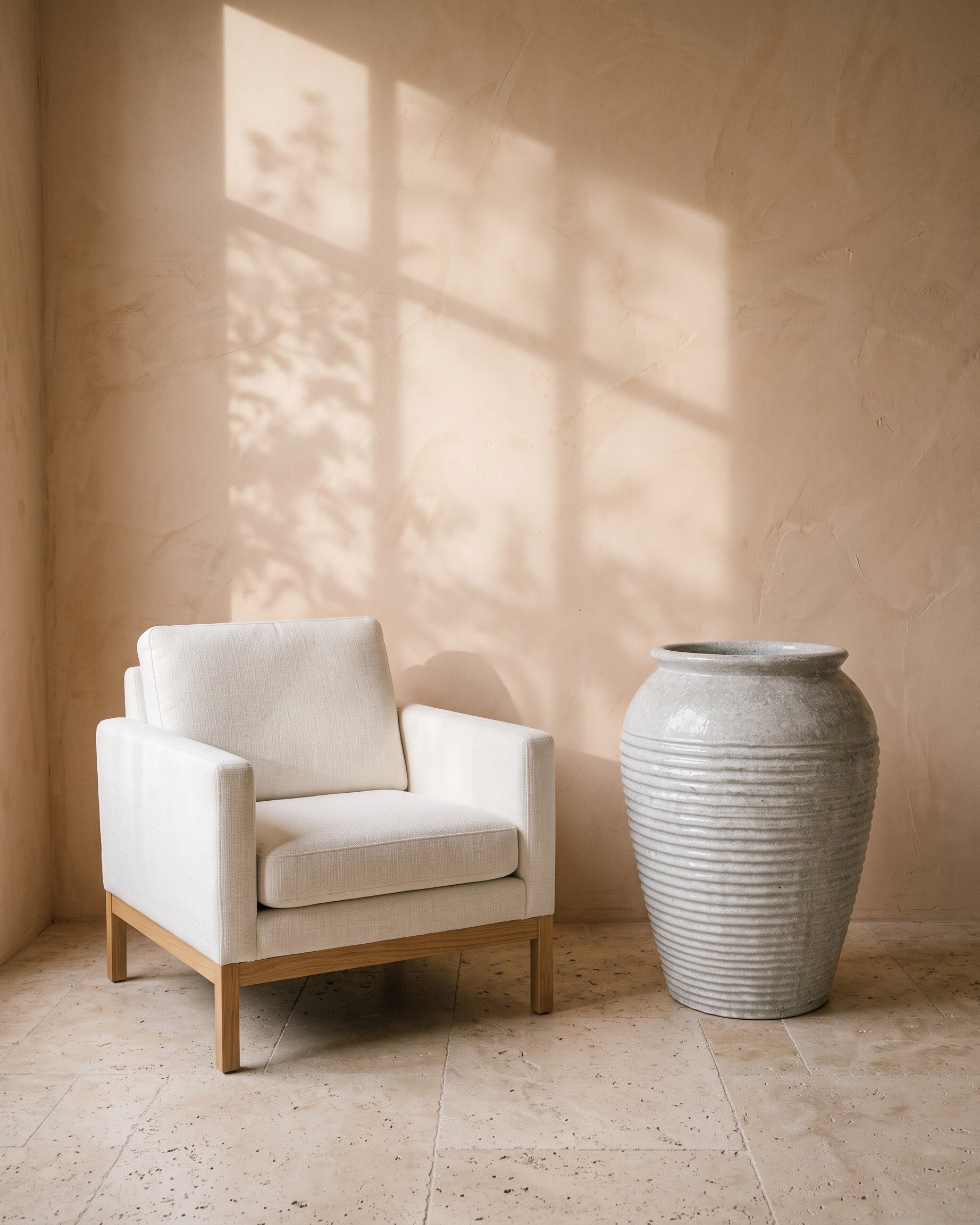 Pearl Lustre Ribbed Jar, shown beside a linen armchair for scale