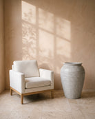 Pearl Lustre Ribbed Jar, shown beside a linen armchair for scale