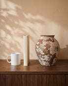 Vintage Mix Vase, shown on a walnut sideboard next to a coffee mug and a book for scale