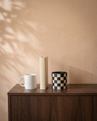 Chess Grid Pot, shown on a walnut sideboard next to a coffee mug and a book for scale