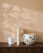 Green Floral Pot, shown on a walnut sideboard next to a coffee mug and a book for scale