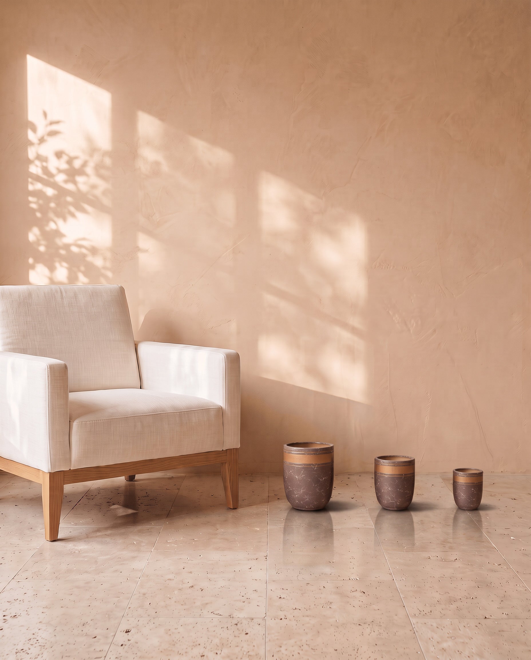 Violet Marble Pot, all sizes, shown on a travertine floor beside a linen armchair for scale